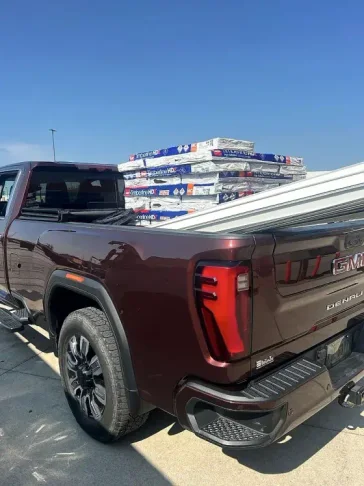 Mendoza Rodriguez truck loaded with shingle pallets for a roofing job