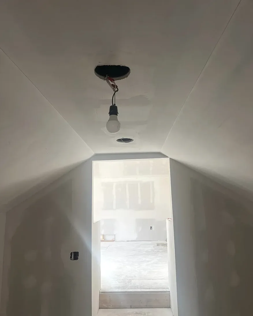 Finished attic hallway in Lorain, Ohio, drywall taped, sanded smooth and ready for paint