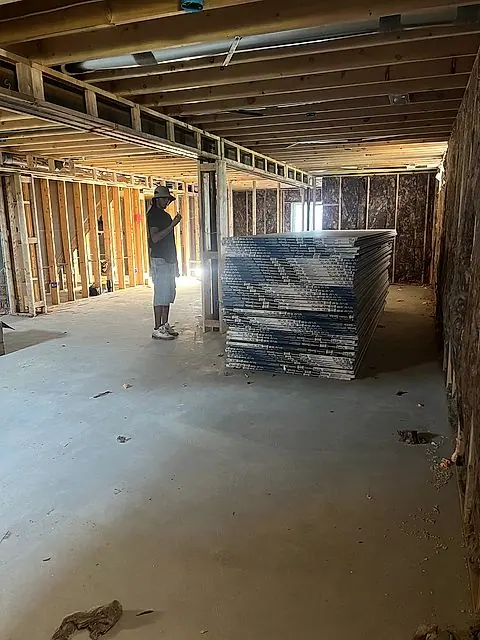 Drywall boards staged in a basement before hanging in Lorain, Ohio
