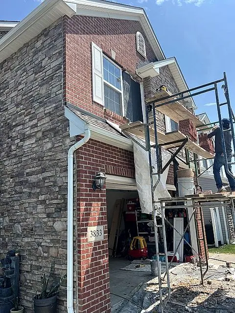 Crew on scaffolding repairing a home exterior in Lorain, Ohio