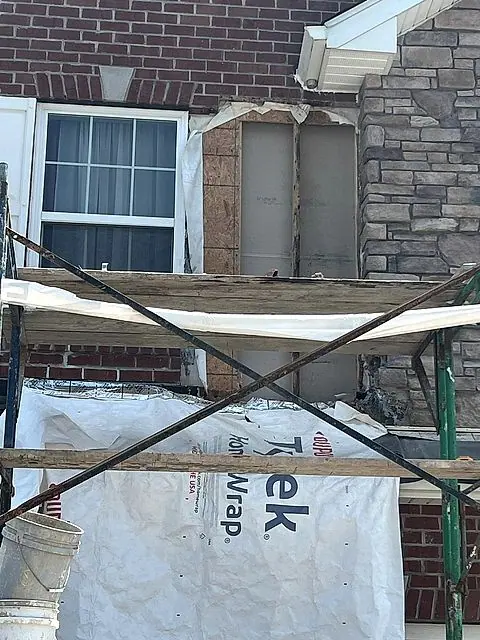 House wrap and scaffolding during an exterior repair in Lorain, Ohio