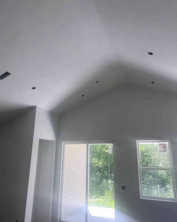 Finished cathedral ceiling, smooth under raking light and ready for paint