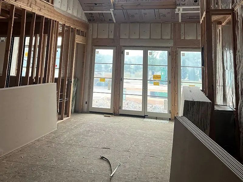 Drywall boards staged and hung on a framed two-story wall in Lorain, Ohio