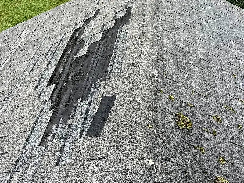Shingle roof section under repair by Mendoza Rodriguez in Lorain, Ohio