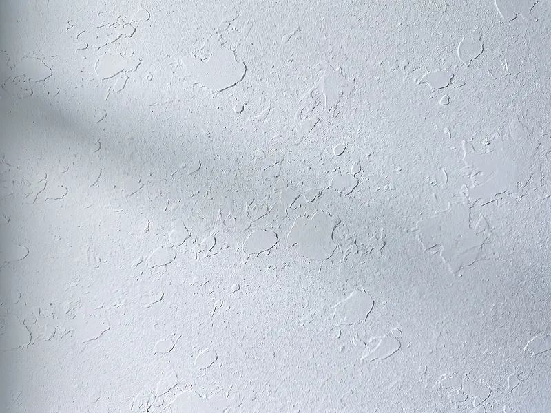 Freshly applied knockdown drywall texture on a paint-ready wall